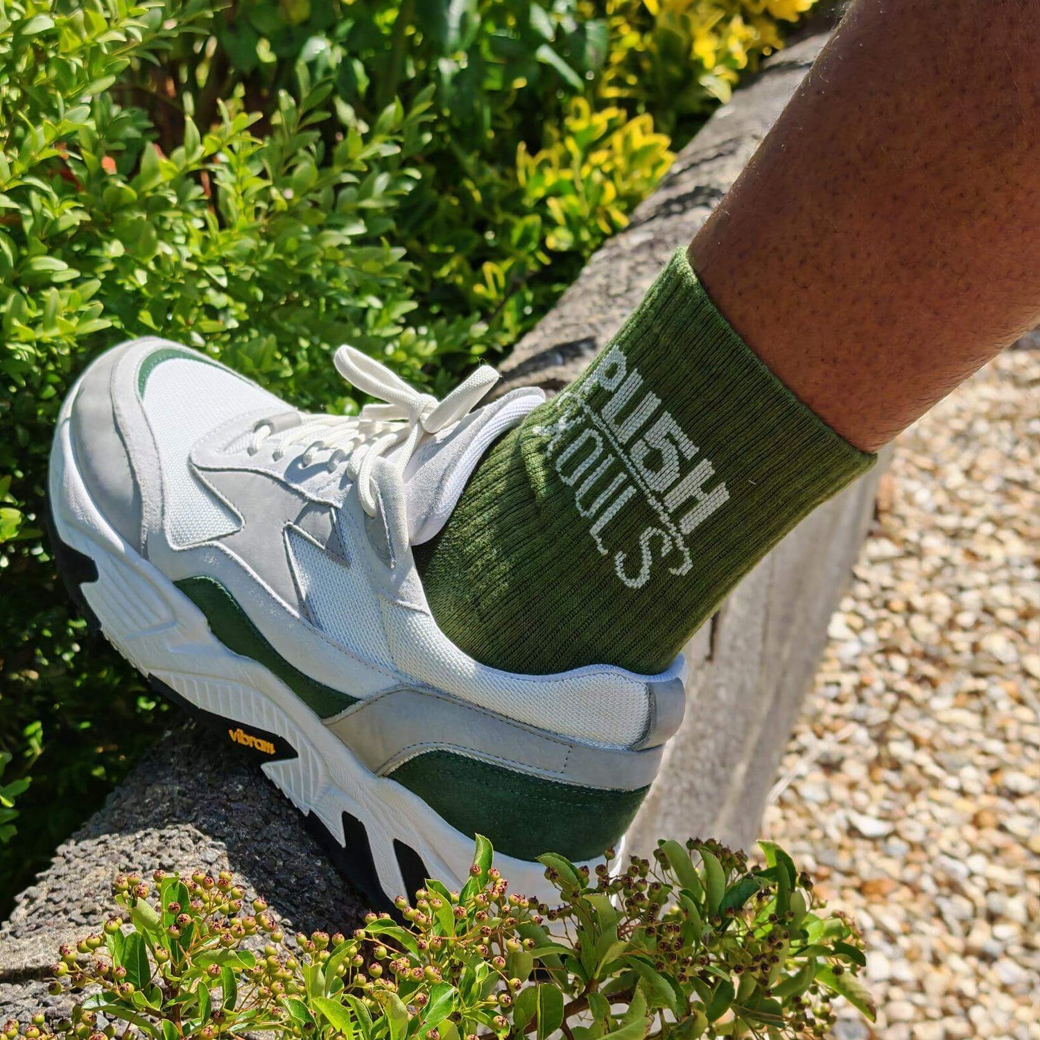 Close-up of mixed color socks for everyday wear paired with stylish sneakers in outdoor setting.